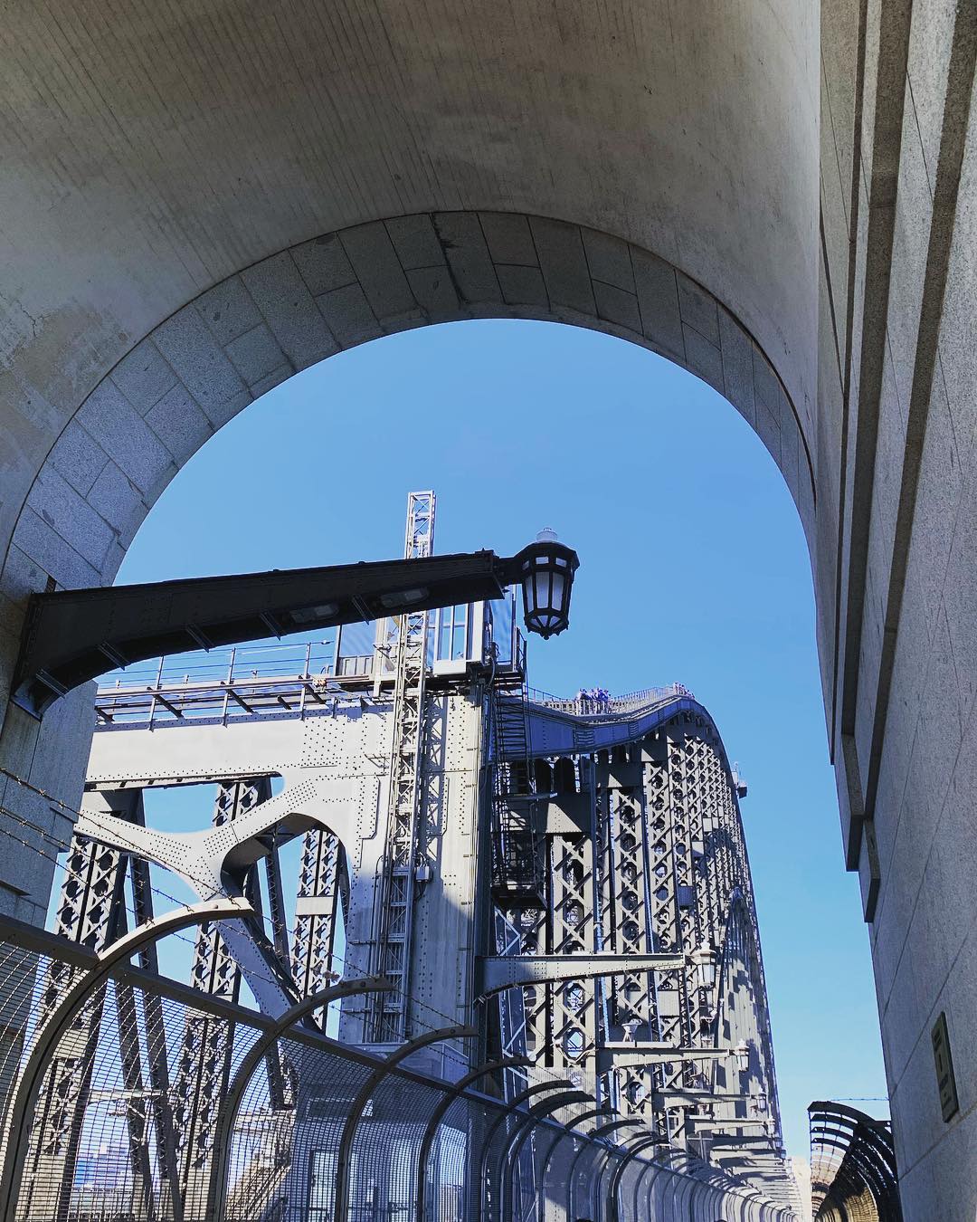 Lining up the curves....the arch of the heavy pylon of the Sydney Harbour Bridge (c. 1932) frames and contrasts with the lightness and delicacy of the curved steel bridge truss work...structural clarity at its best......